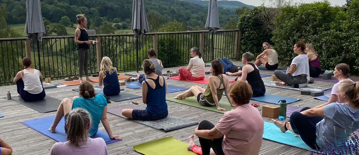 A yoga class outside at a previous retreat
