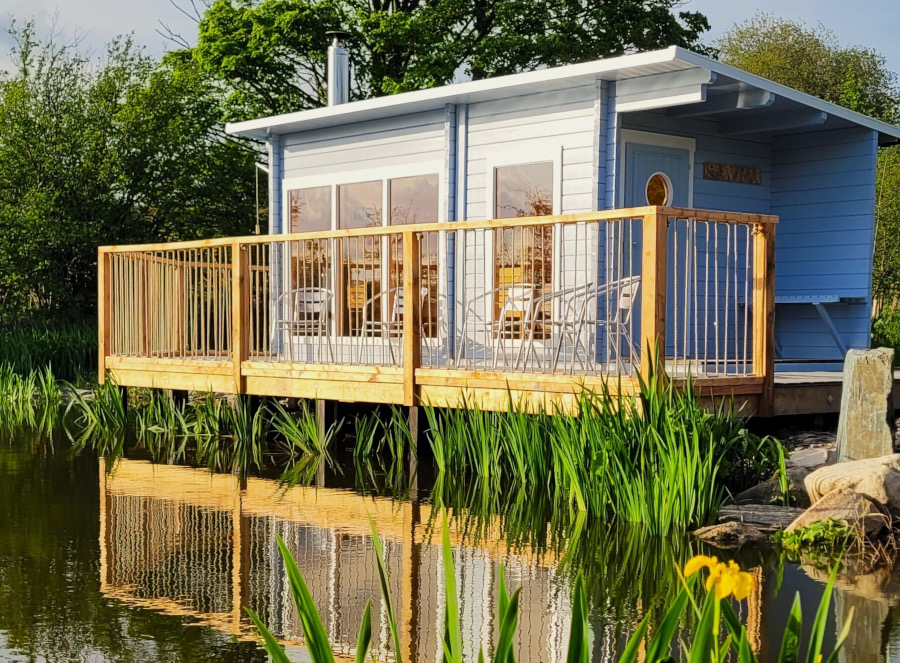 The sauna cabin on its deck overlooking the wild pond at The Forge