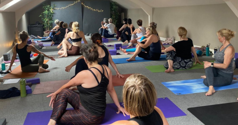 A yoga class inside in the yoga room.